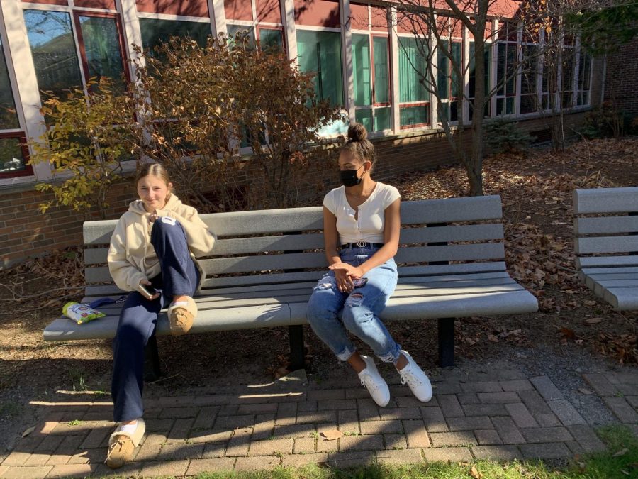 Freshmen Anke Shact and Sloan Hinton social distance outside in the WHS courtyard. 

