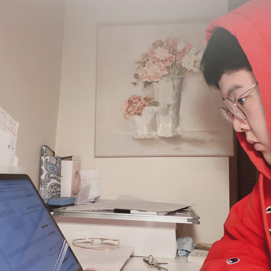 Senior Junbo Li works on his college applications.