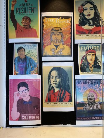Diversity posters hang in library display case