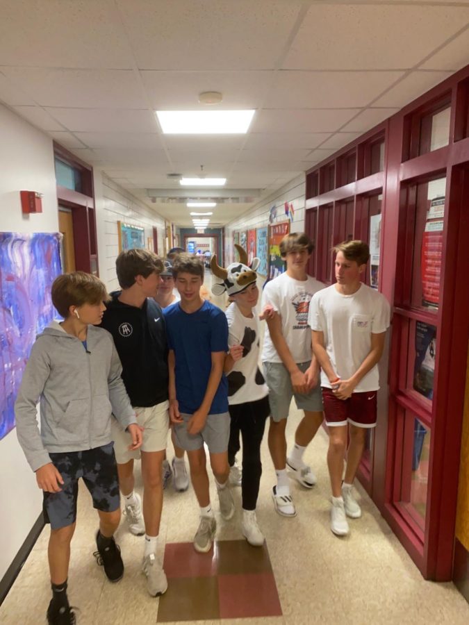 Senior pushes past freshmen who are blocking the hallway