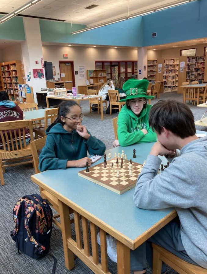 Students play chess in the WHS library.                            PHOTO/Kate Lemons