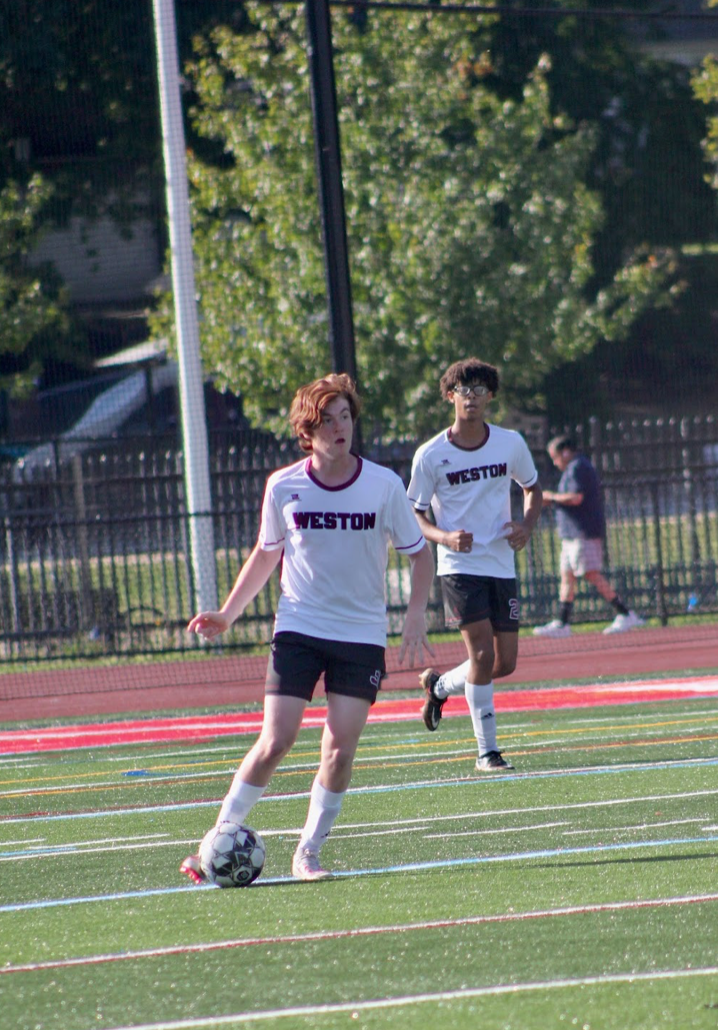 Flores competes in a soccer game representing WHS.