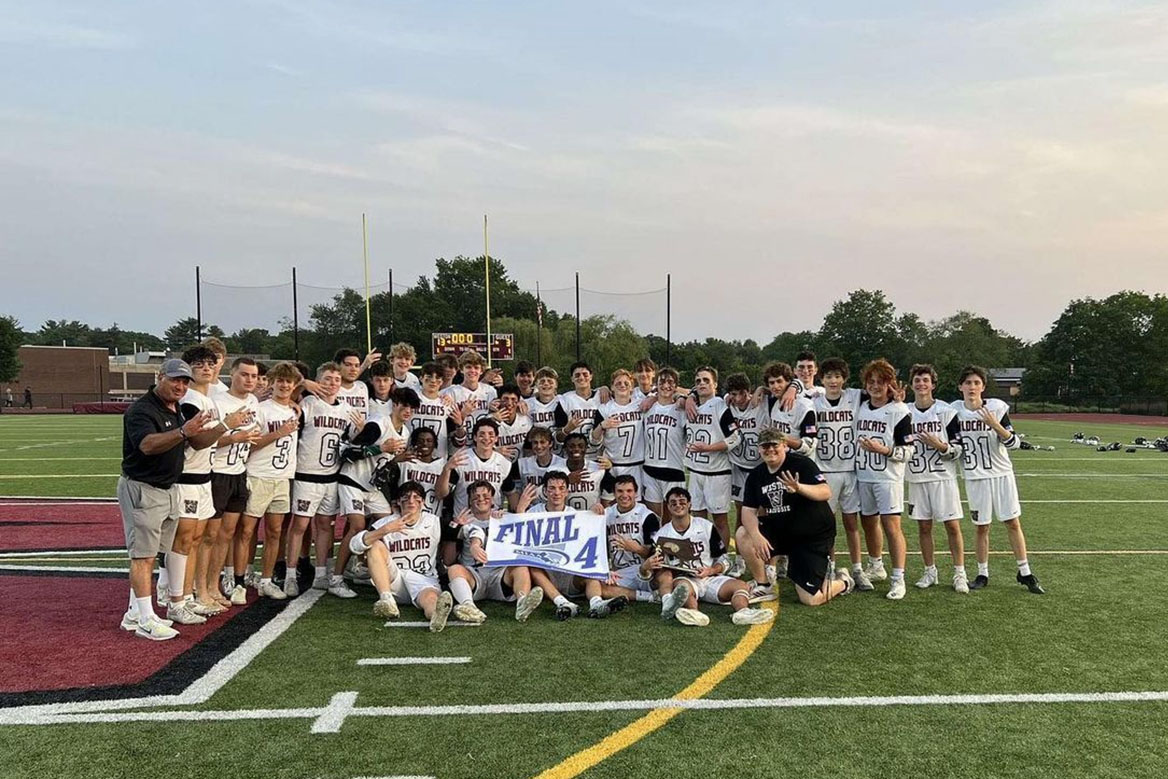 Boys lacrosse team gathers after playoff win

