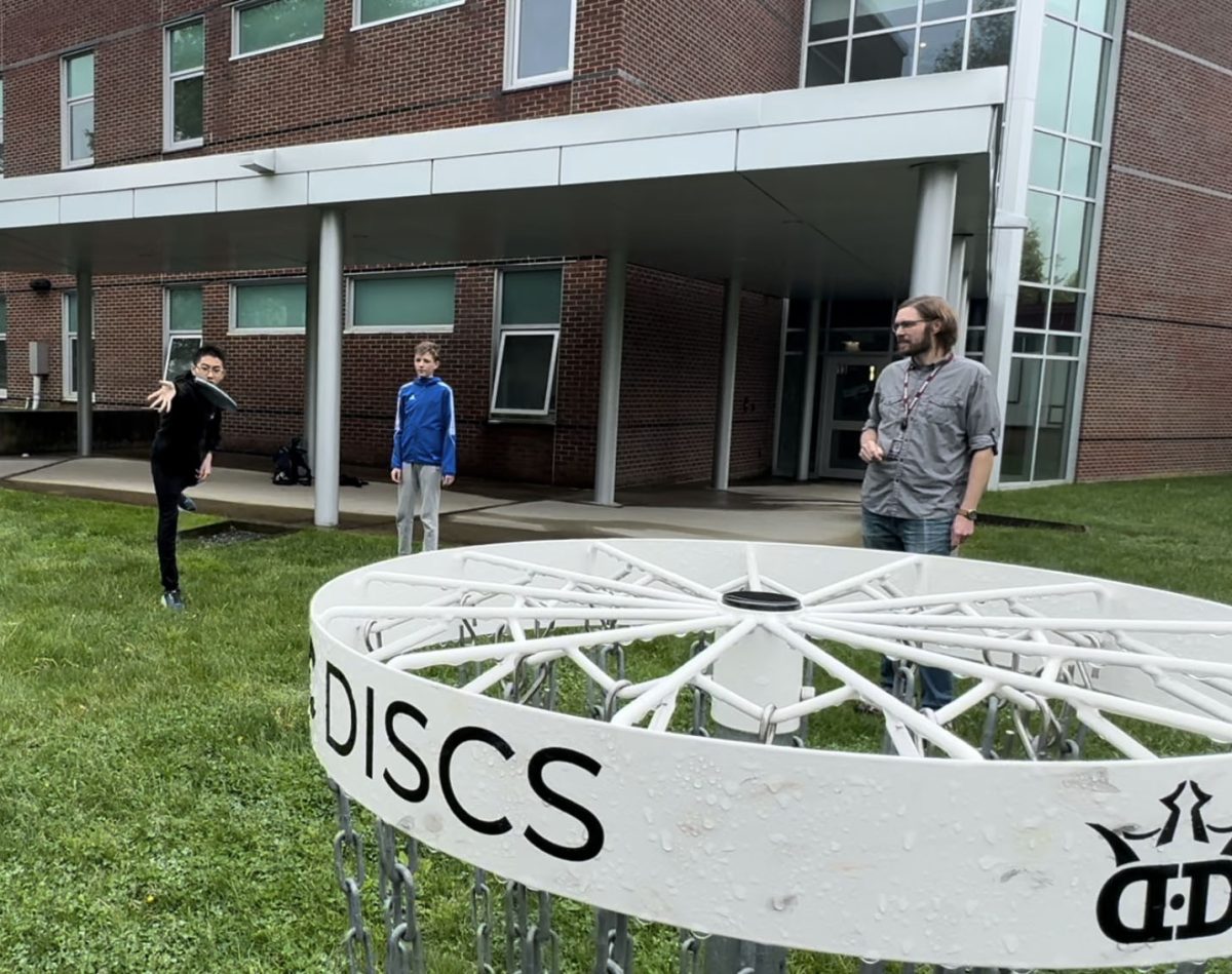 Student attempts to throw disc in net
