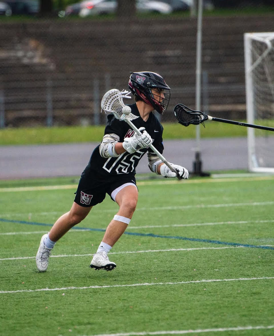 Henry Kano competes in a lacrosse game
