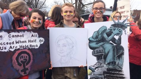 Sophomore Ryan Aldrich, Ryan Hayes, and Freshmen Helen Townsend march at the Boston Women's March for America