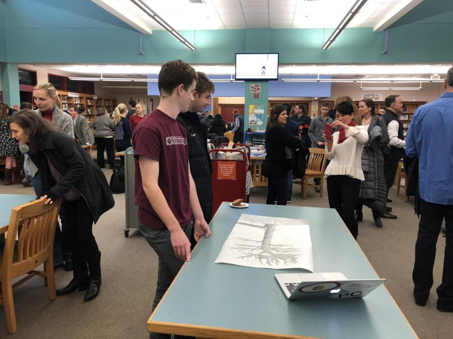 Andrew Gumbert and Jack Lenox display their artistic project at the event. 