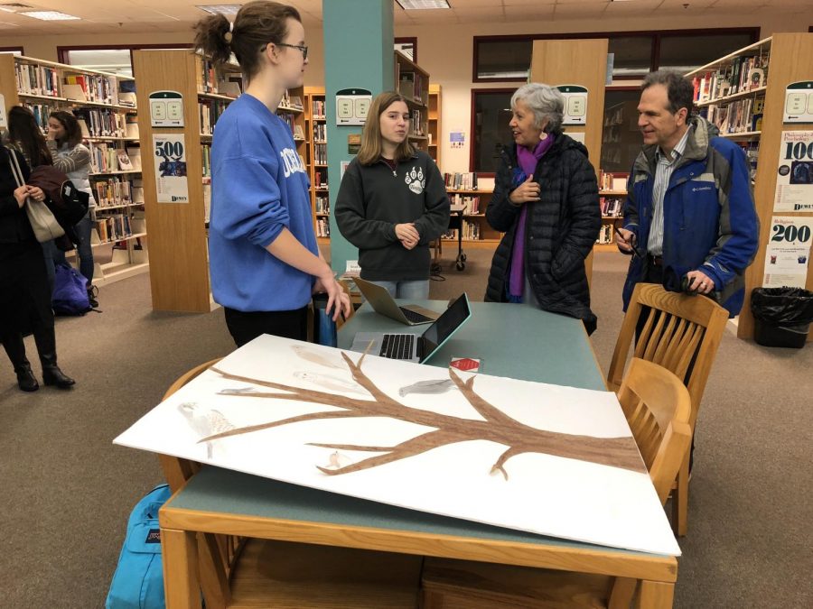 Catherine Ayer and Kimberly Nicholson present their projects to an audience.