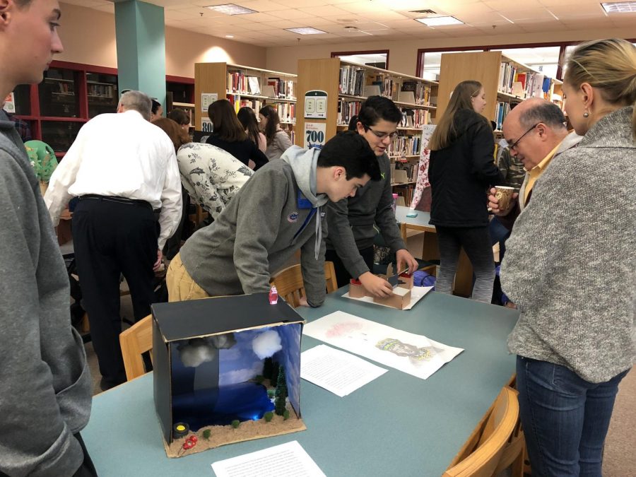 Matthew Roan and Eric Sakkas in action with guests in attendance.