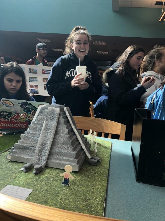 Junior Katerina Cummings enjoying the atmosphere while presenting her sculpture. 