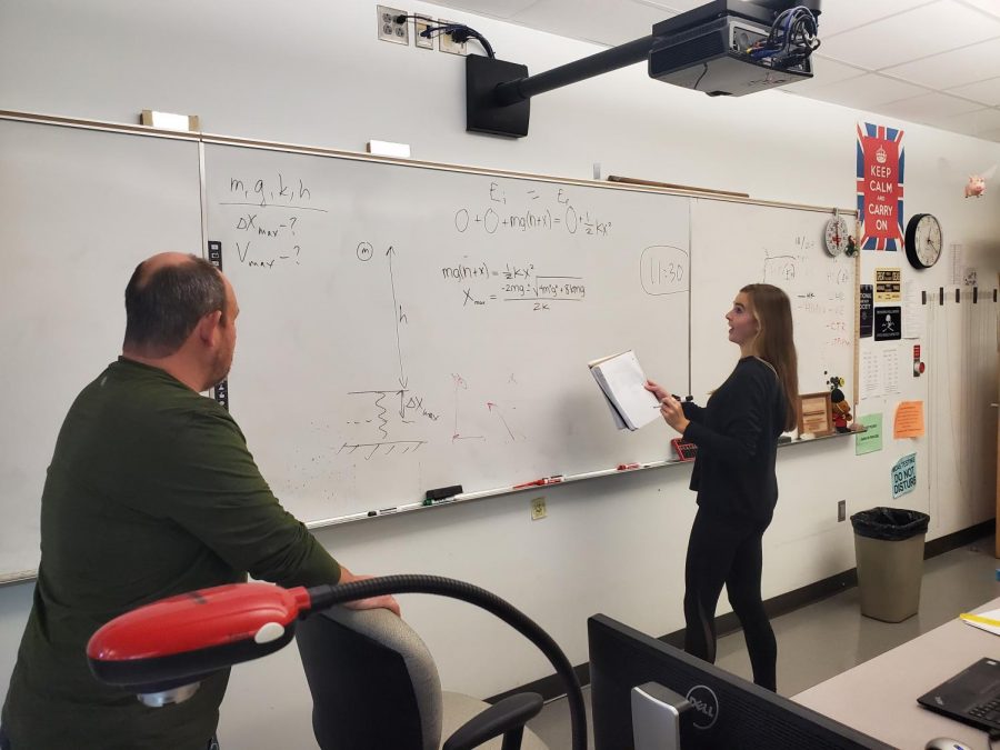 Science teacher Boris Korsunsky helps senior Lila Kosowsky solve a
problem during an AP Physics class.