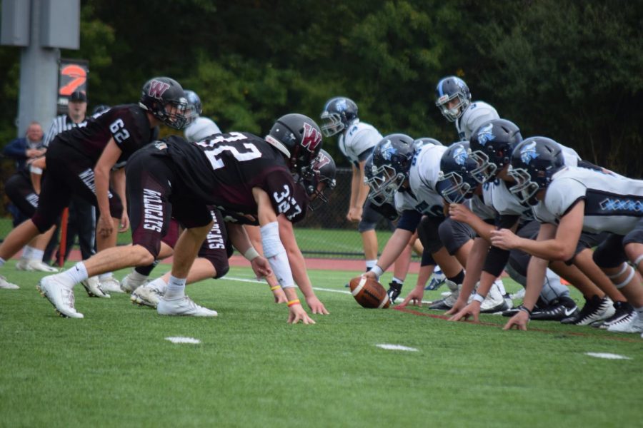 Weston lines up against Triton Regional High School’s offensive line.