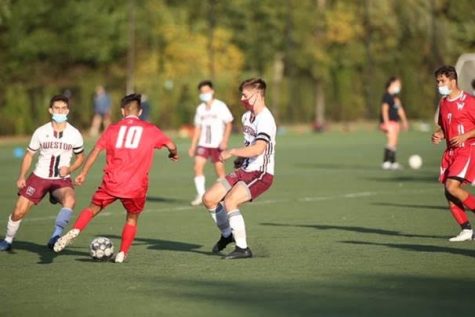 Senior co-captain’s Jackson Tabors and Nick Ginovker defends a Waltham player in their soccer match.