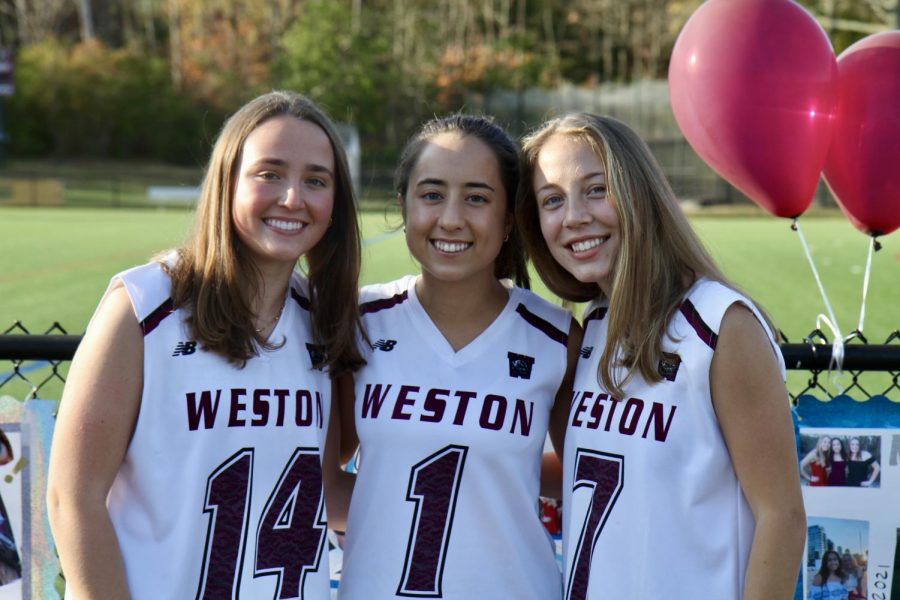 Field hockey captions Jackie Goode, Maya Malenfant, and Lily Heslem pose for a photo.