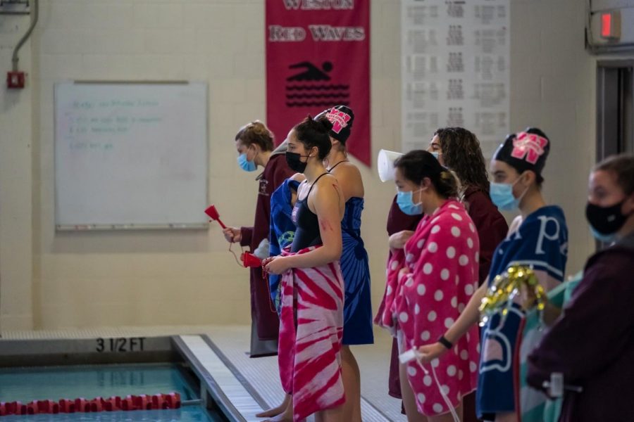 Red Tide swimmers safely watch their teammates compete in a socially-distanced meet.