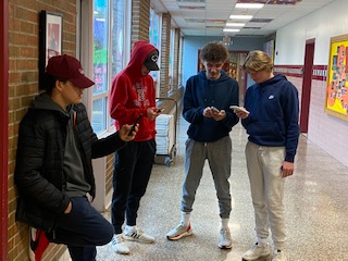 WHS students using their phones in the hallway 