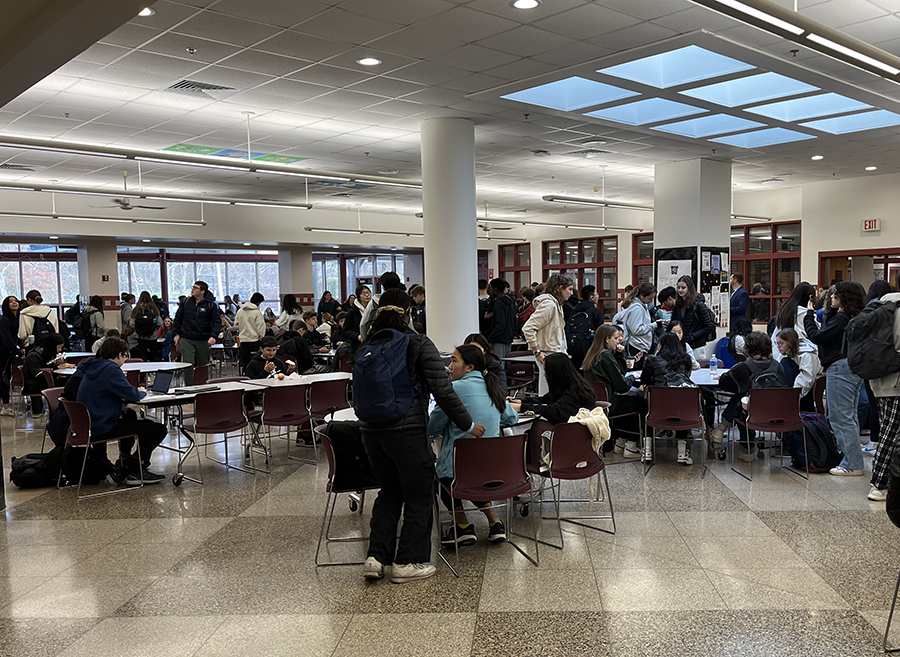 Students converse in their cafeteria sections before going to class			