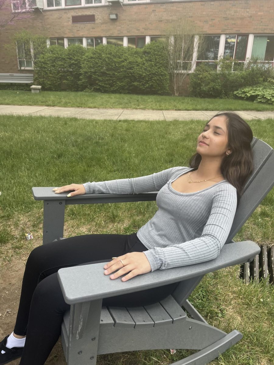 Student tanning in the WHS courtyard during lunch