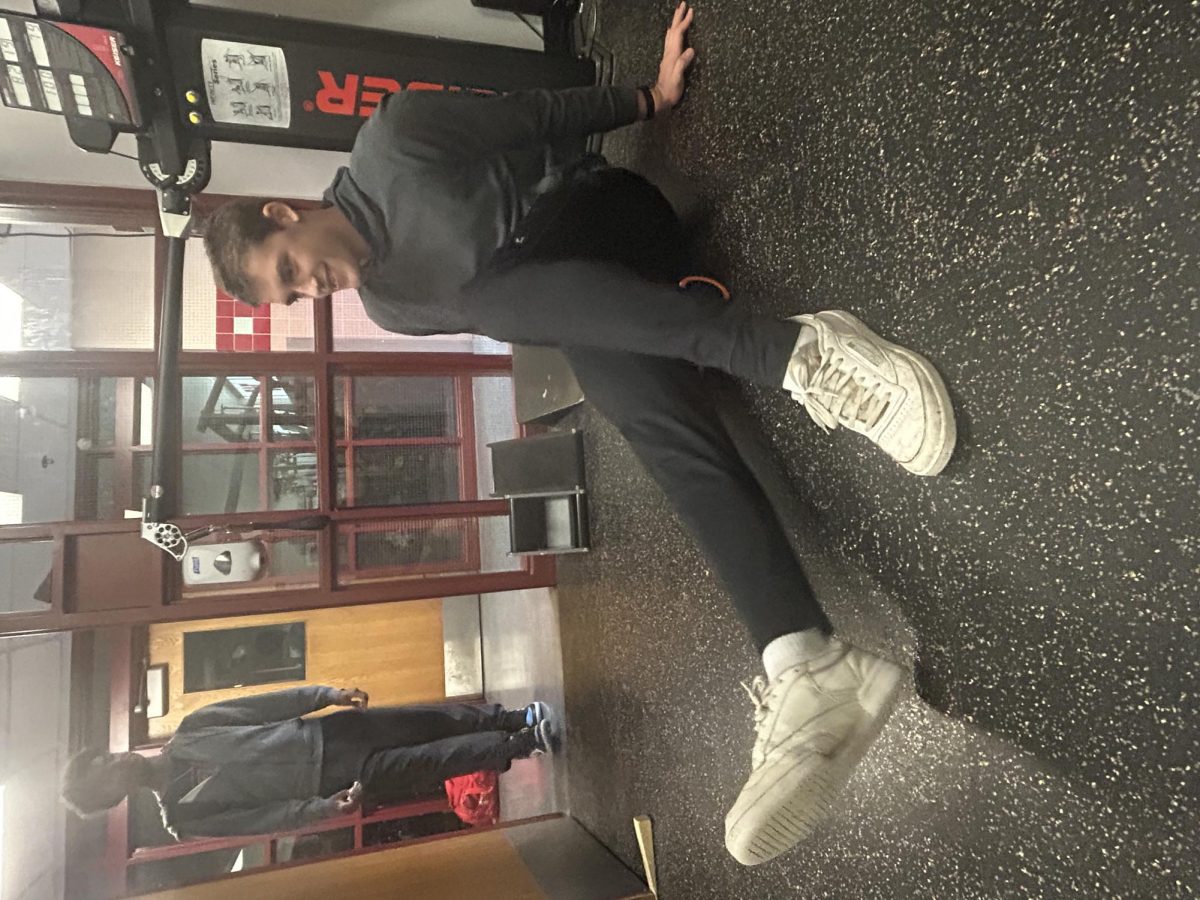Senior Massimo Selvig stretching on a foam roller
