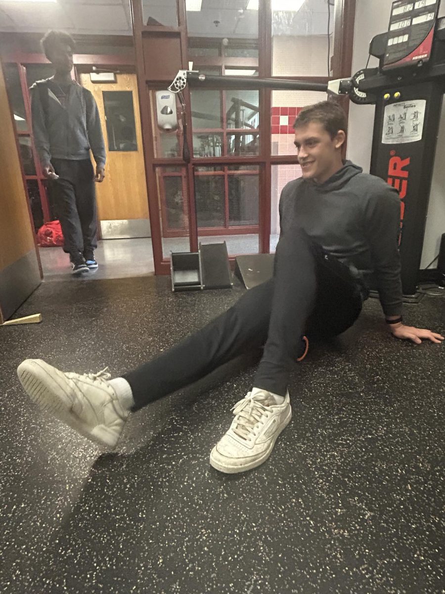Senior Massimo Selvig stretching on a foam roller